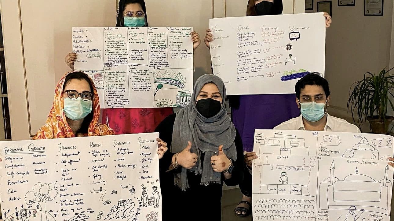 Live coaching session — participants with vision boards